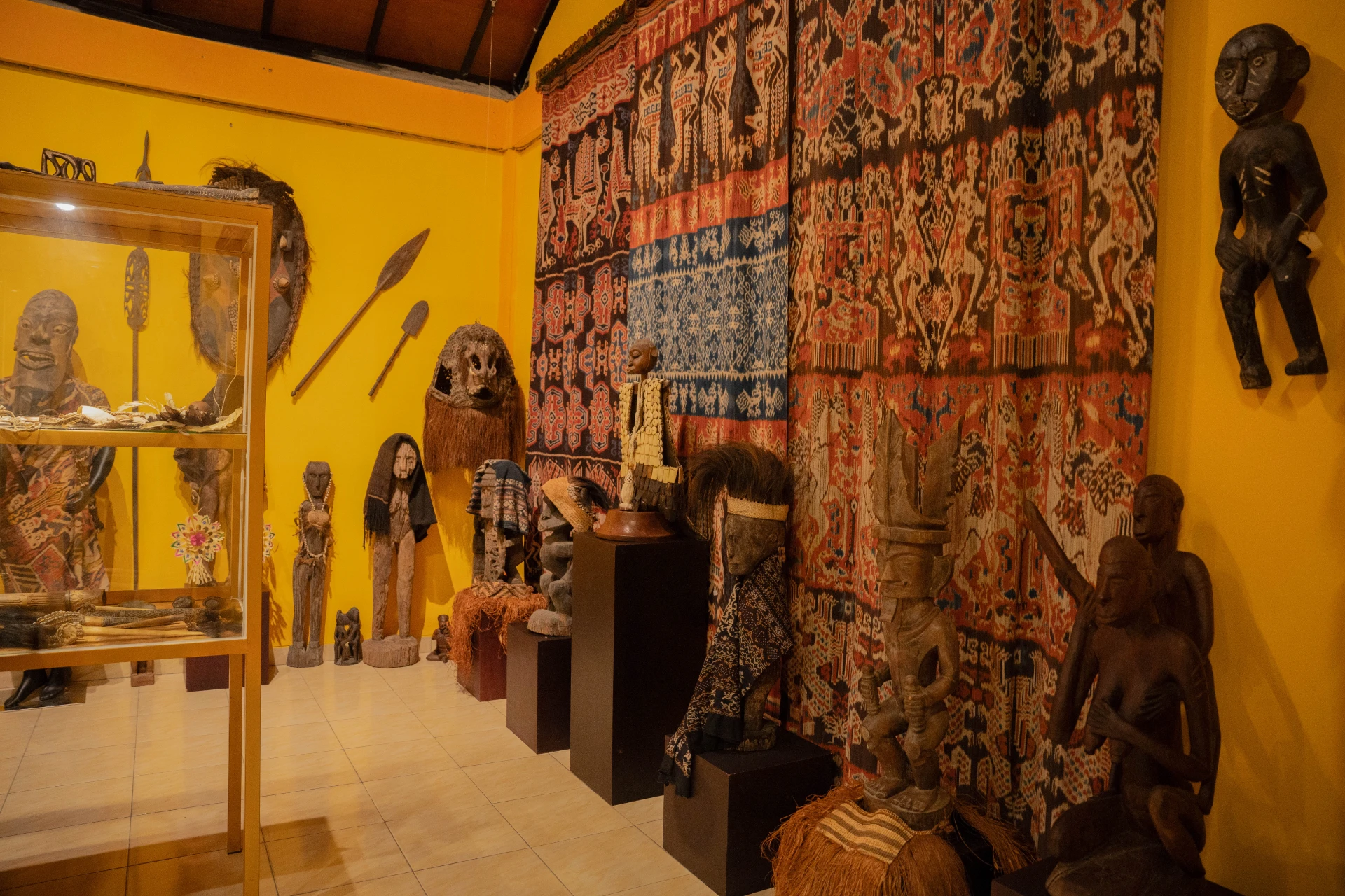 Small historical statues and spiritual sculptures related to Annemarie Kipar's collection in the Scary Room exhibit.
