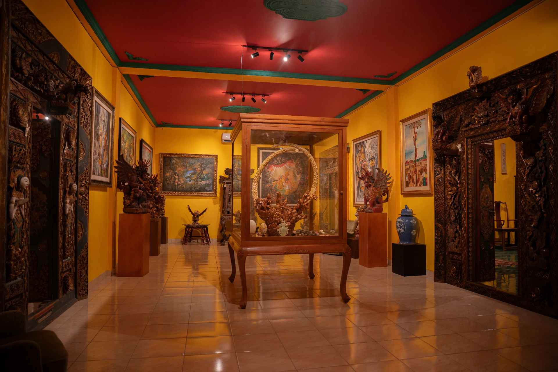 Close view Balinese Bale Gede wooden pavilion with intricate hand-carvings, Museum Peter Bloch Collection.