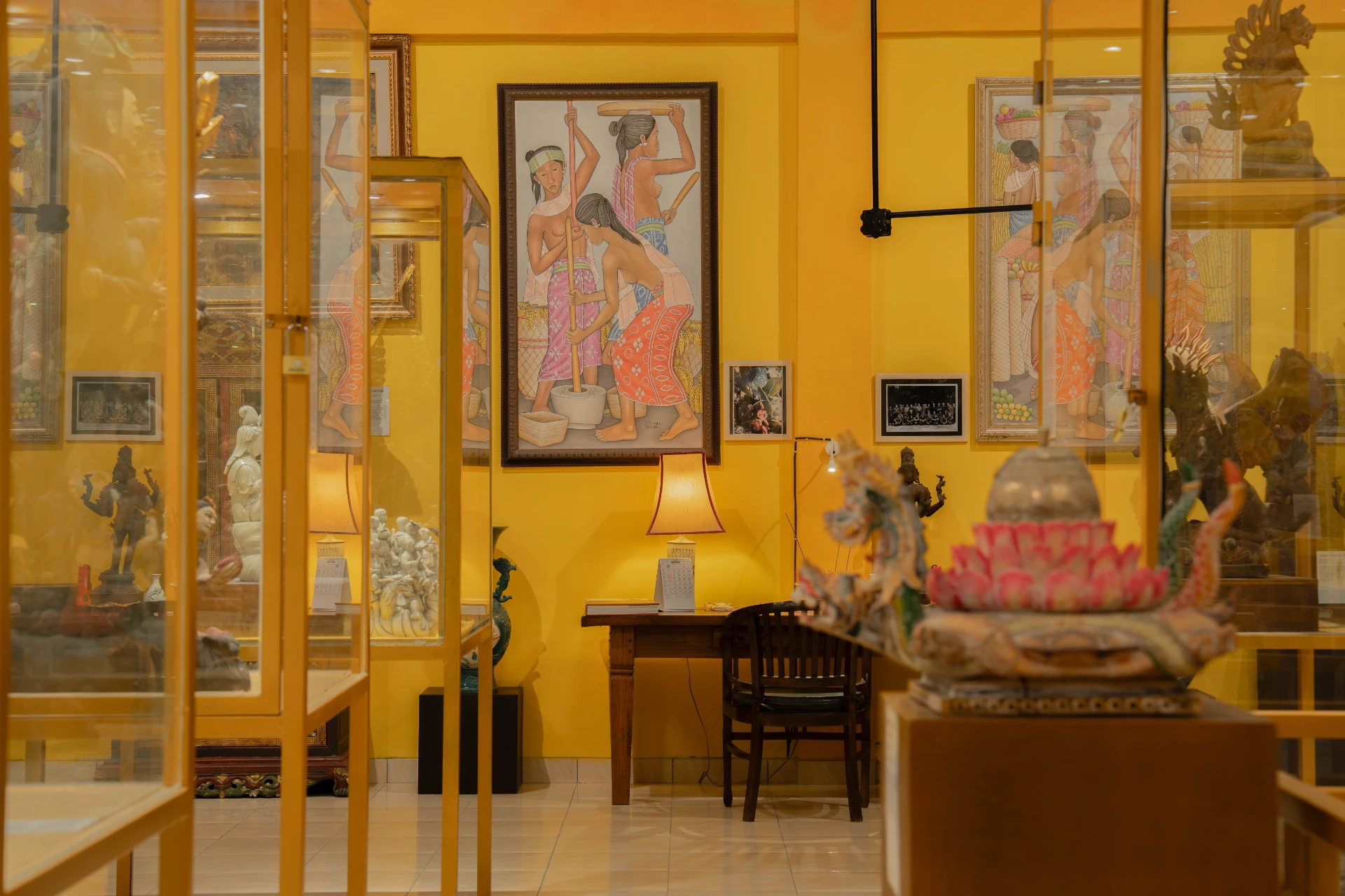 Framed archival sketches and historical documents on the vibrant red walls of the Mads Lange Bedroom.