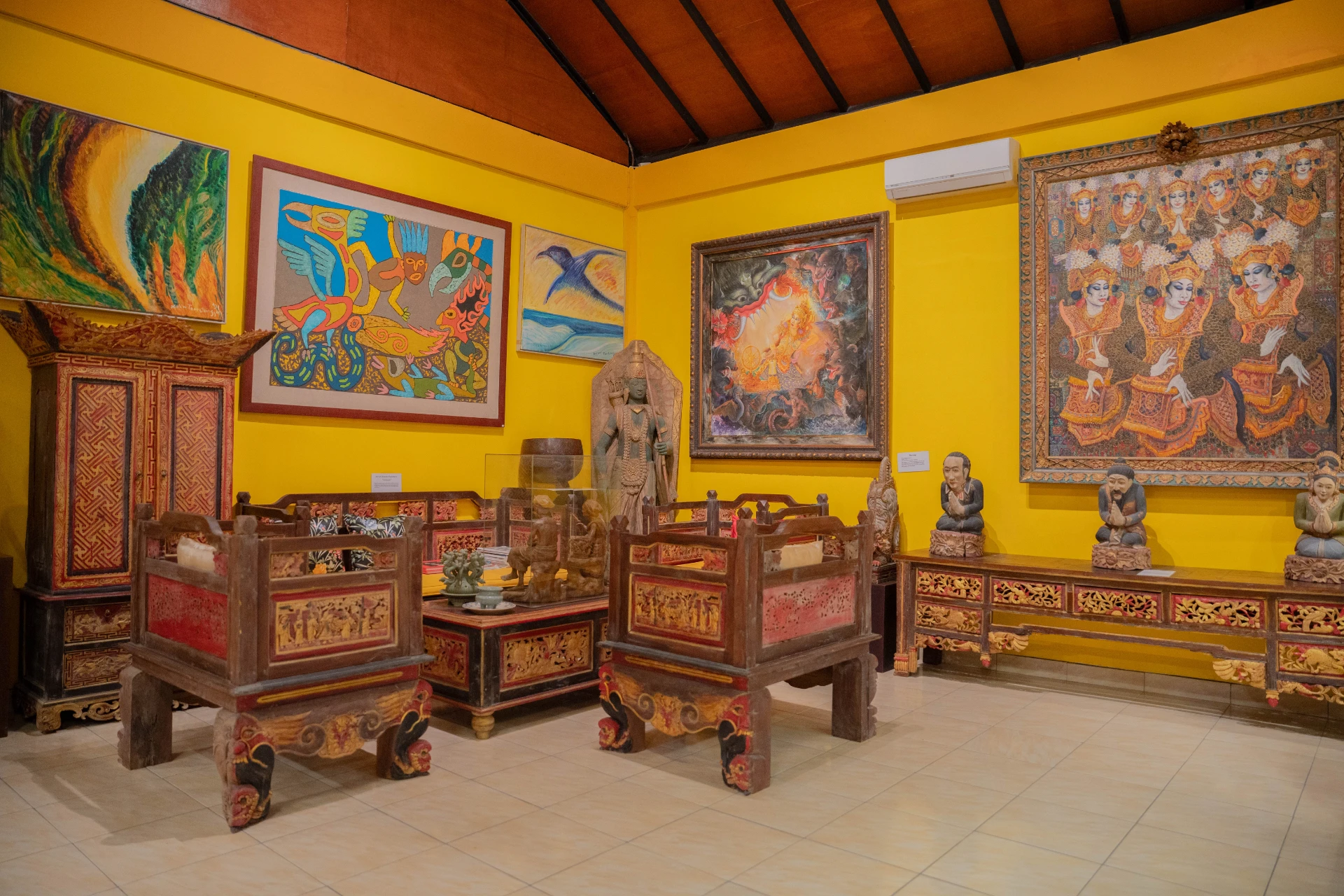 Collection of antique bronze figurines and historical archives in the Mads Lange Sitting Room, Museum Peter Bloch Collection.